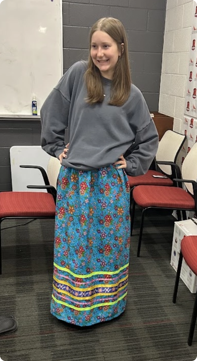 Student proudly modeling their ribbon skirt