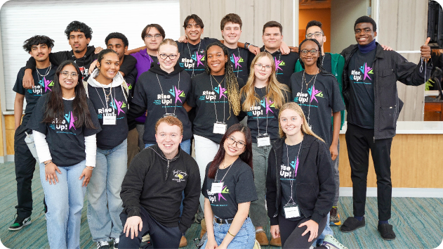 Group of Students posing for a photo all wearing RISE Up shirts